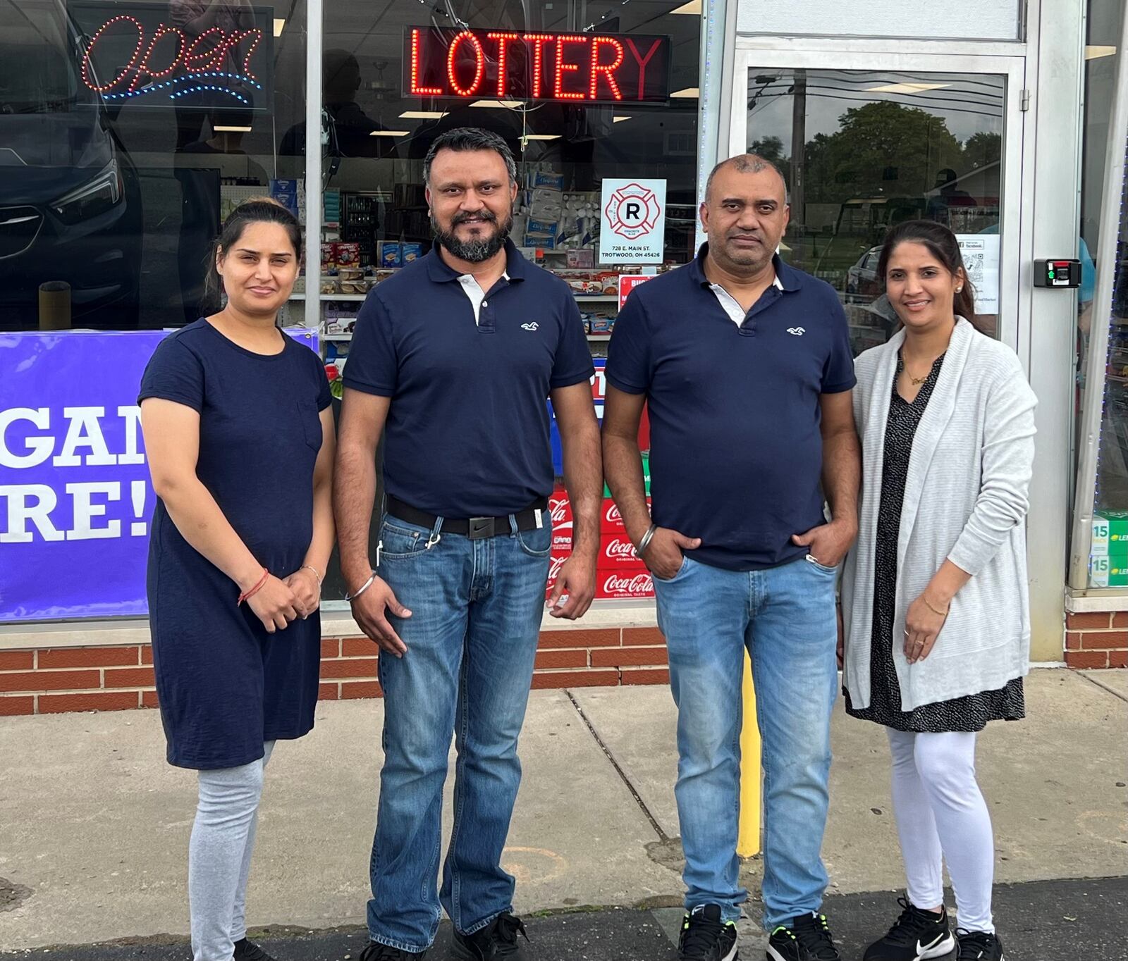 Brothers Navi and Sunny Singh, along with their wives Mona, left, and Reena, are owners of Main Street Food Market, which opened last month in Trotwood. AIMEE HANCOCK/STAFF