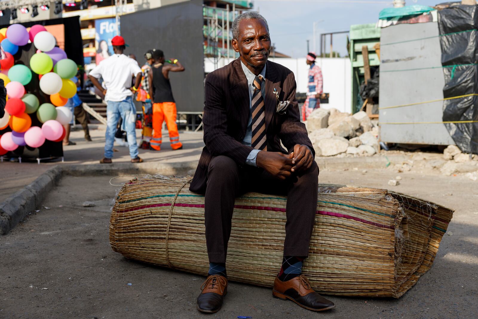 A man dressed in second-hand clothes attends a thrift and an upcycle show in Accra, Ghana, Sunday, Oct. 27, 2024. (AP Photo/Misper Apawu)