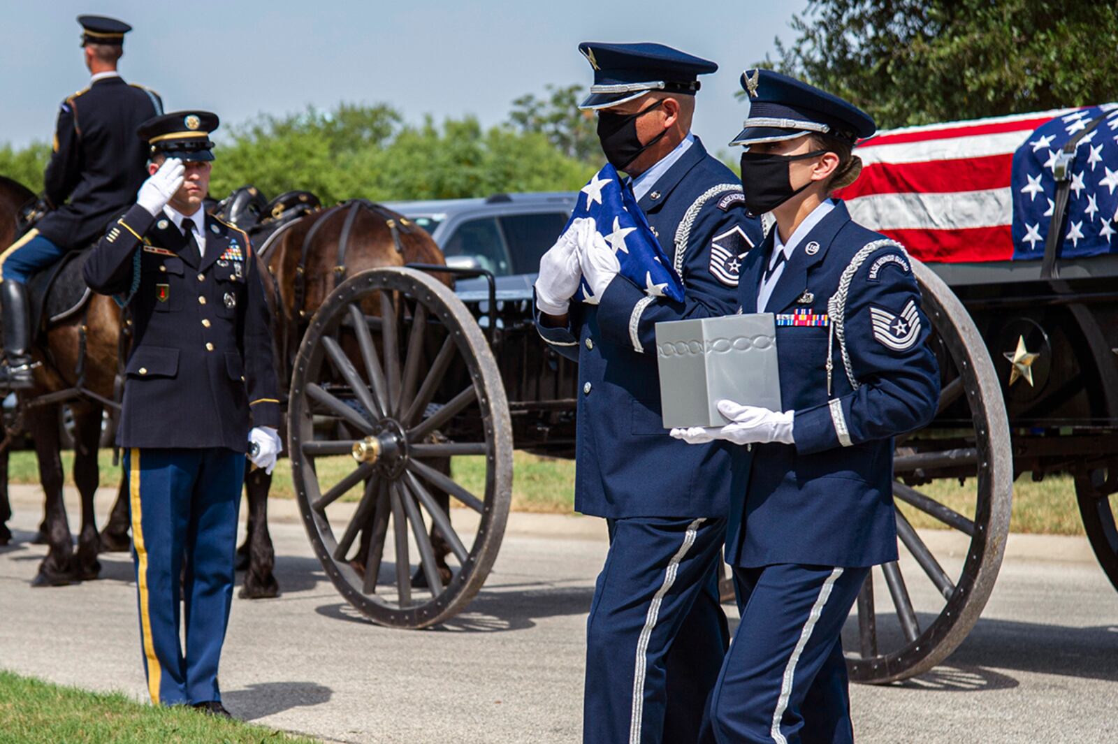 Air Force Honor Guard members carry the remains of retired Col. Richard E. Cole and the U.S. flag during his interment, Sept. 7, 2021, at the Fort Sam Houston National Cemetery, Texas. All Doolittle Raiders were awarded the Congressional Gold Medal in May 2014. U.S. AIR FORCE PHOTO/TRISTIN ENGLISH