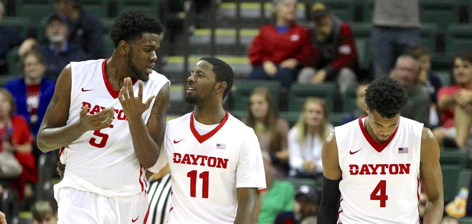 Dayton’s Scoochie Smith, center, talks to Steve McElvene after McElvene picked up his fourth foul against Monmouth in the semifinals of the Orlando Classic on Friday, Nov. 27, 2015, at the HP Field House in Orlando, Fla. David Jablonski/Staff