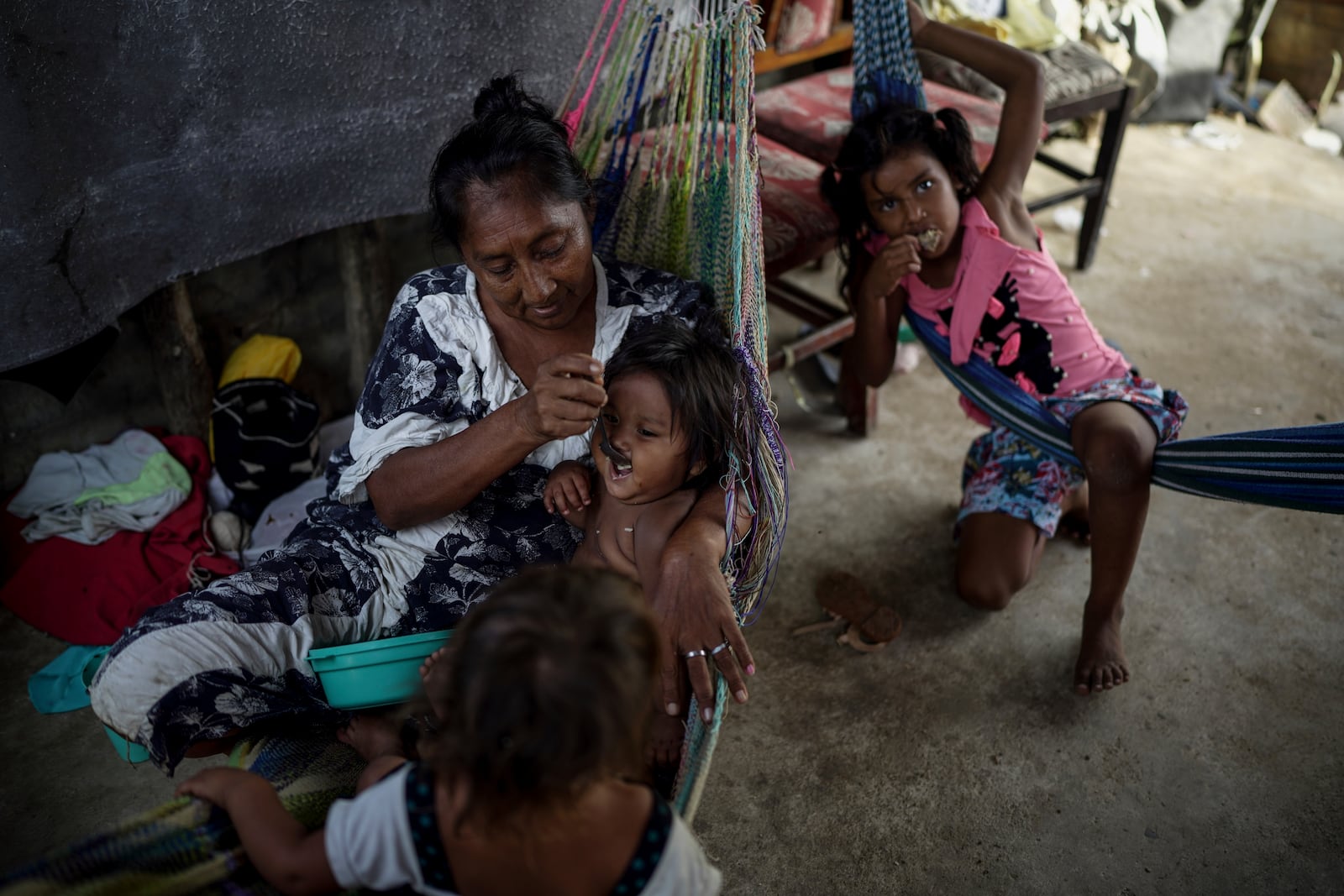 An Indigenous woman from the Wayuu community feeds her baby in the Belen neighborhood on the outskirts of Riohacha, Colombia, Tuesday, Feb. 4, 2025. (AP Photo/Ivan Valencia)