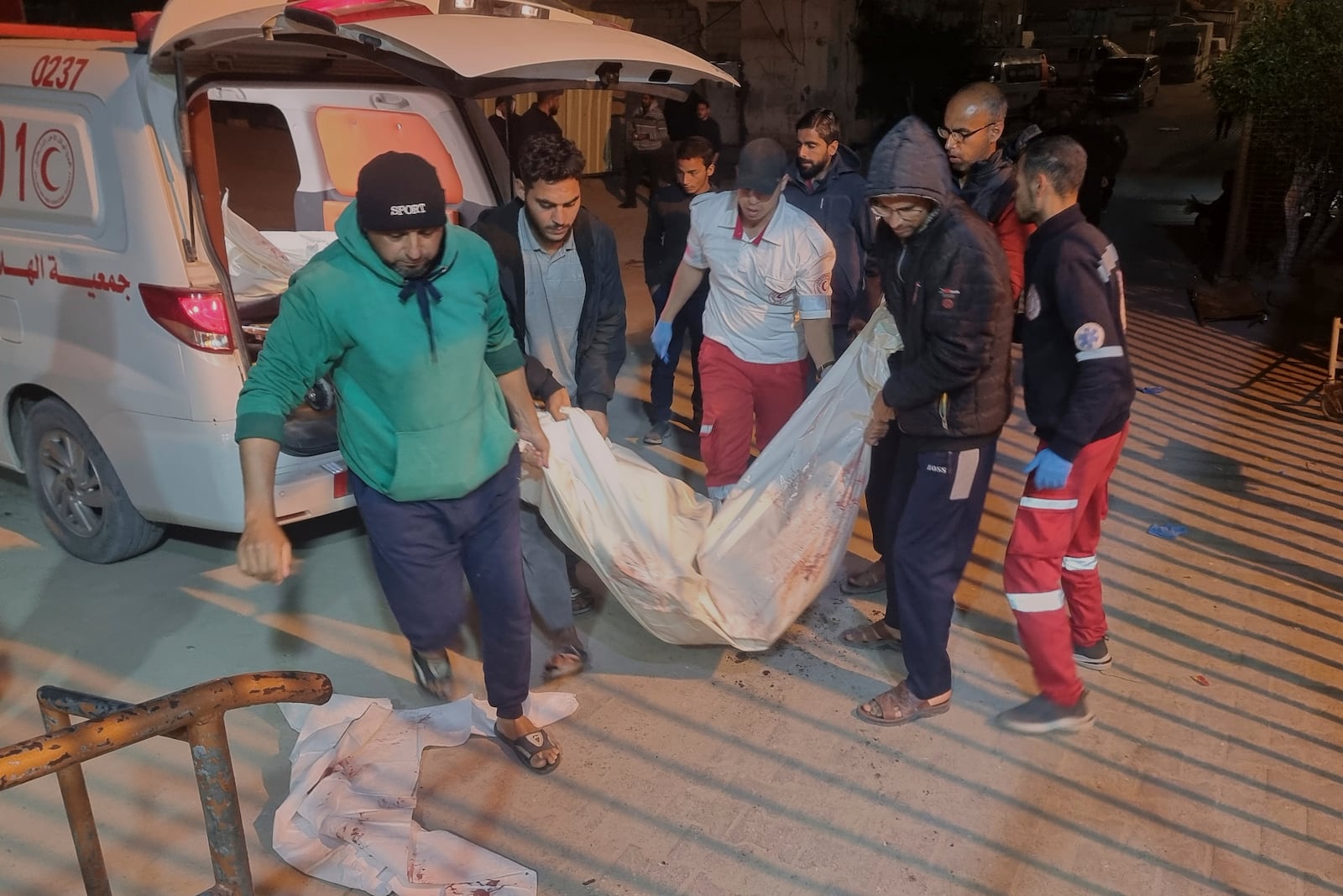 A dead person killed during an Israeli army strike is taken into the hospital in Khan Younis, southern Gaza Strip, Tuesday March 18, 2025.(AP Photo/ Mohammad Jahjouh)