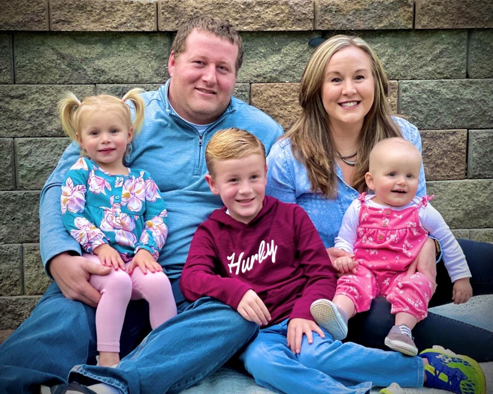 Patrick (top left) and Mallory Truster (top right) are feeling blessed this Christmas after their youngest daughter Kayleigh (bottom right) has overcome a brain tumor. The Truster family, which also includes Kelly (bottom left) and Nick (middle), live in St. Mary's and came to Dayton Children's Hospital for treatment for Kayleigh, who was diagnosed with infantile glioblastoma. CONTRIBUTED