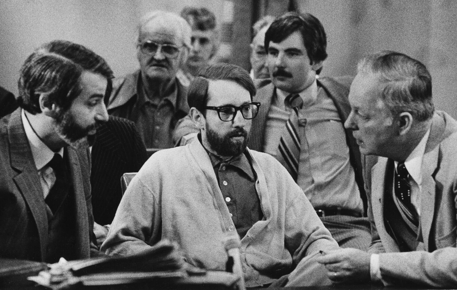 FILE - Mass murderer James Ruppert, center, listens to his attorneys, H.J. Bressler, left, and Hugh Holbrook, right, as they prepare to ask for a change of venue retrial on March 18, 1980 in Butler County Common Pleas Court in Hamilton, Ohio. Ruppert, 88, who was serving a life sentence for the shooting deaths of 11 family members - including eight children - died Saturday, June 4, 2022, at the prison system's Franklin Medical Center in Columbus. (AP Photo/Jeff Hinckley, File)