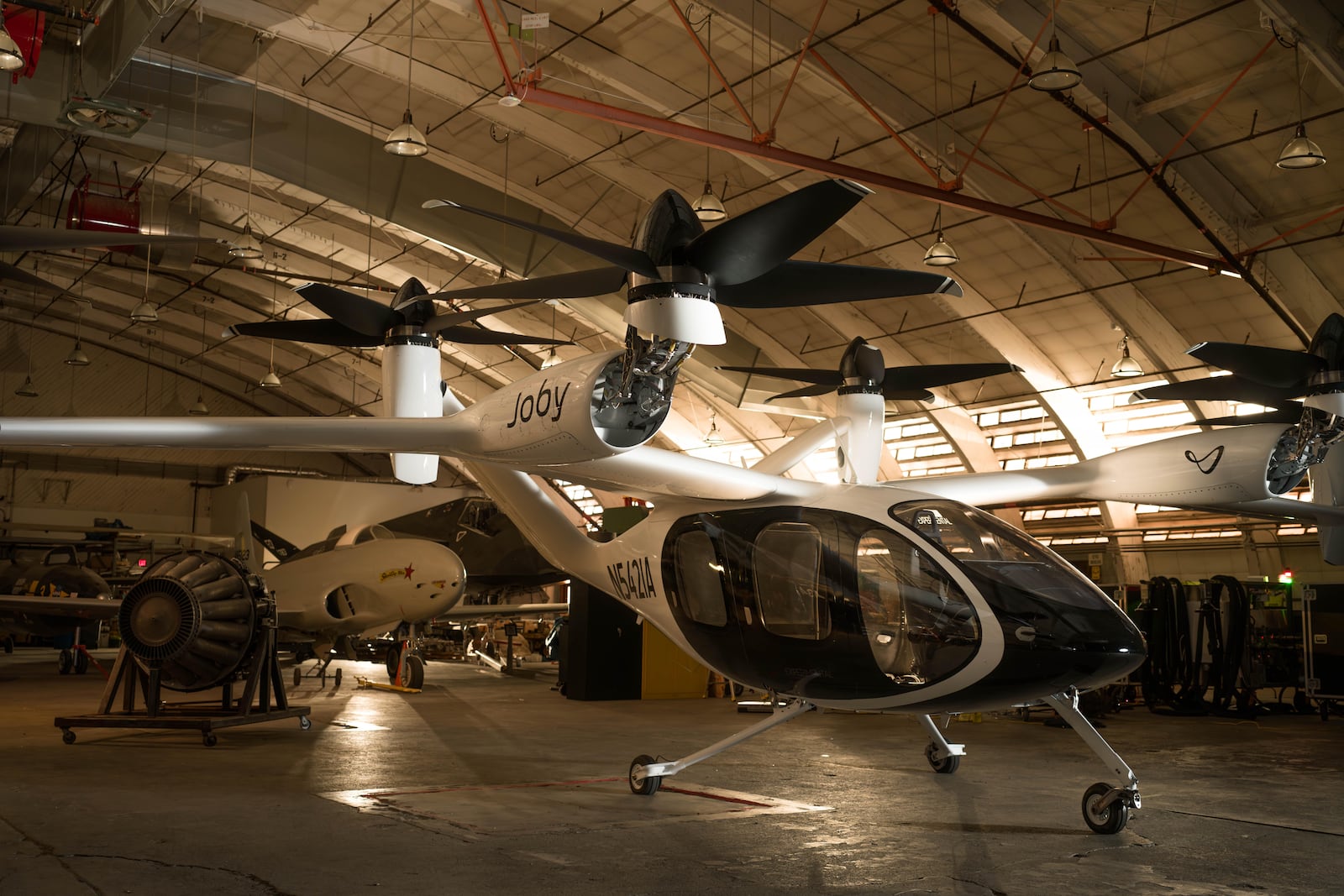 Joby’s electric vertical take-off and landing (eVTOL) aircraft, recently delivered to Edwards Air Force Base, alongside a number of revolutionary, historic aircraft first tested at the base. (Photo Credit: Joby Aviation)