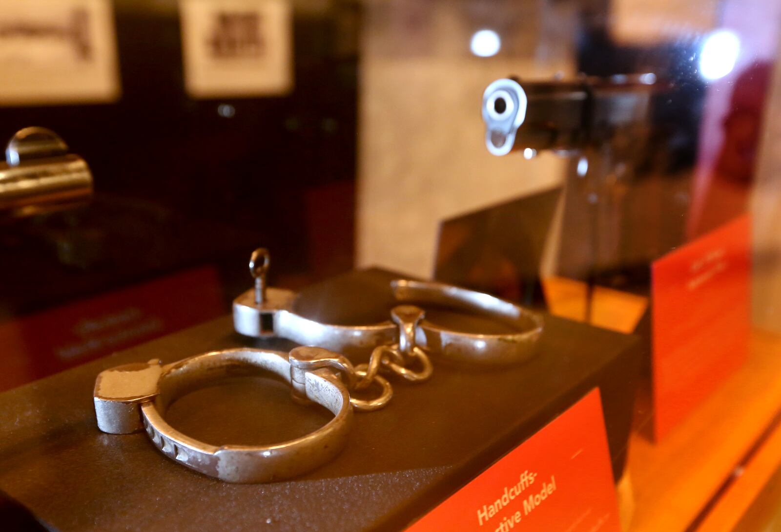 The handcuffs slapped on gangster John Dillinger during his 1933 arrest in Dayton are on display at Carillon Historical Park's latest exhibition, Bootleggers, Bandits, and Badges: From Dry Times to Hard Times in Dayton, Ohio. LISA POWELL / STAFF