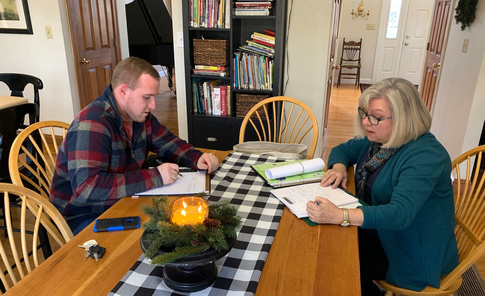 Chris Lewis and interior designer Sharon Bledsoe go over plans for the renovation and design of the historic Dayton home Lewis owns that once belonged to Gov. James M. Cox. LISA POWELL / STAFF