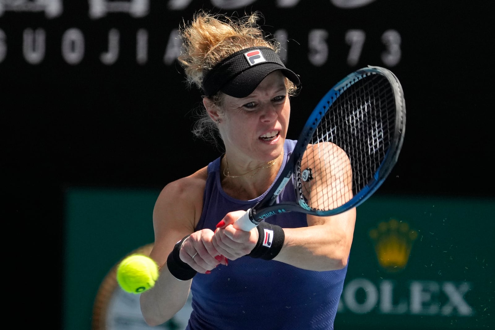 Laura Siegemund of Germany plays a backhand return to Anastasia Pavlyuchenkova of Russia during their third round match at the Australian Open tennis championship in Melbourne, Australia, Friday, Jan. 17, 2025. (AP Photo/Manish Swarup)