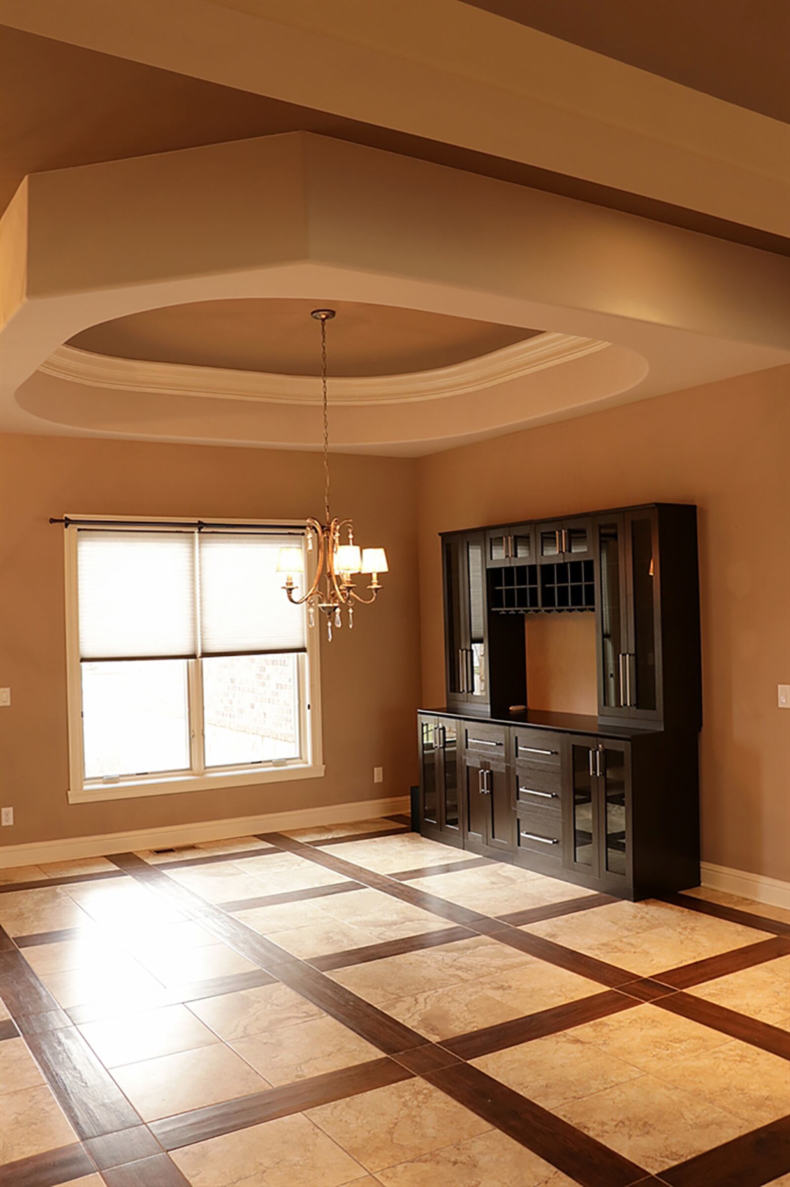 A reverse tray ceiling encircles the dining area, which has a built-in buffet and wine cabinetry, complete with bottle shelves and glass racks. CONTRIBUTED PHOTO BY KATHY TYLER