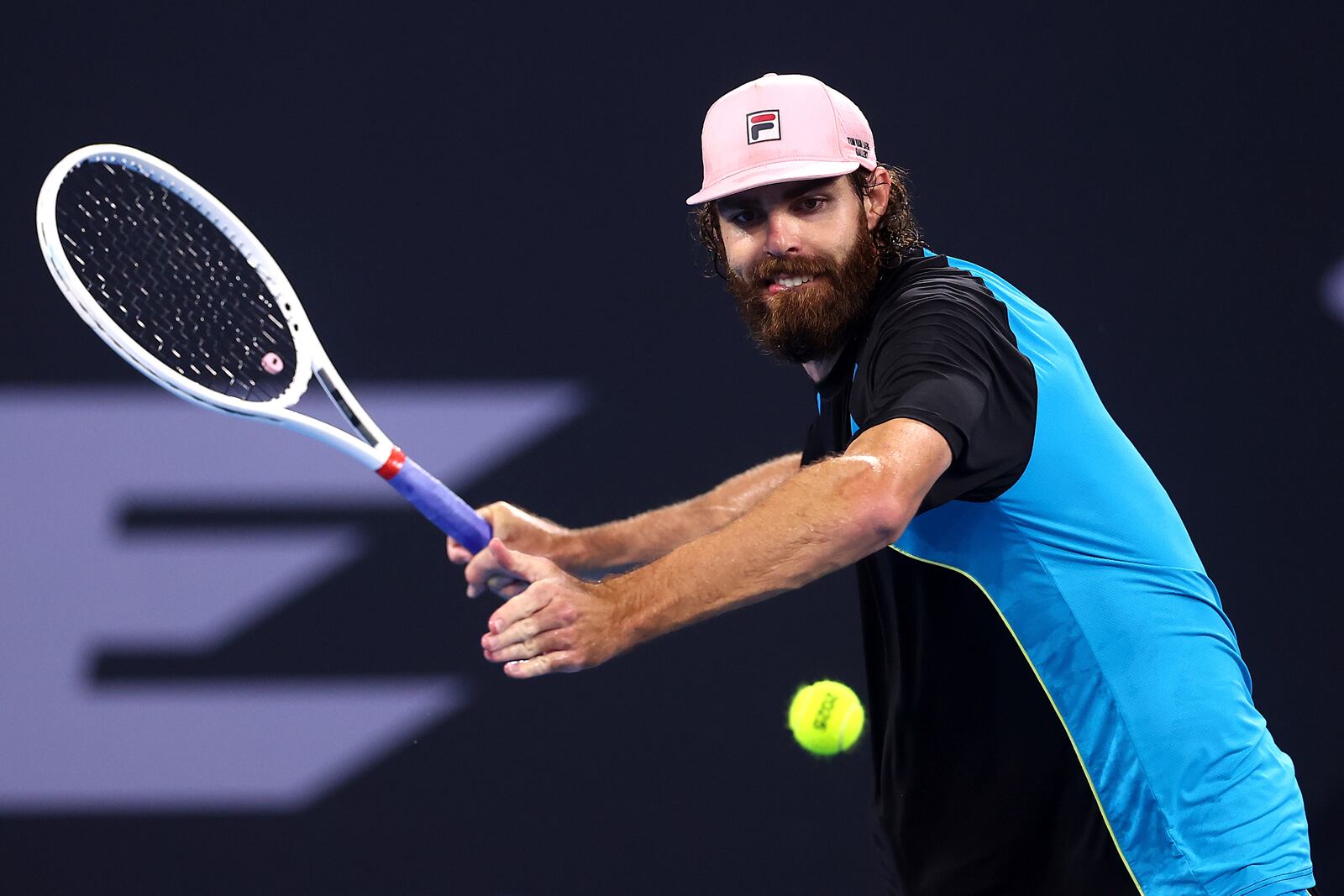 USA's Reilly Opelka plays a backhand to Serbia's Novak Djokovic during their match at the Brisbane International, in Brisbane, Australia, Friday, Jan. 3, 2025. (AP Photo/Pat Hoelscher)