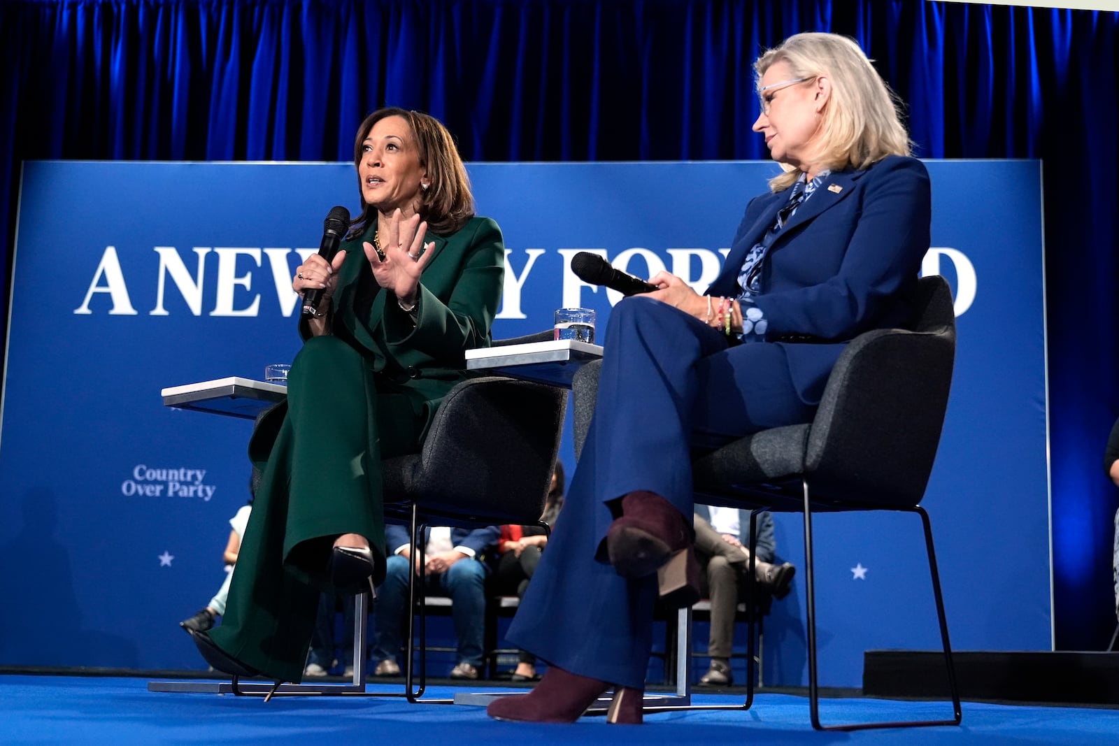 Democratic presidential nominee Vice President Kamala Harris speaks as former Republican Congresswoman Liz Cheney listens during a town hall at the Royal Oak Theatre in Royal Oak, Mich., Monday, Oct. 21, 2024. (AP Photo/Jacquelyn Martin)