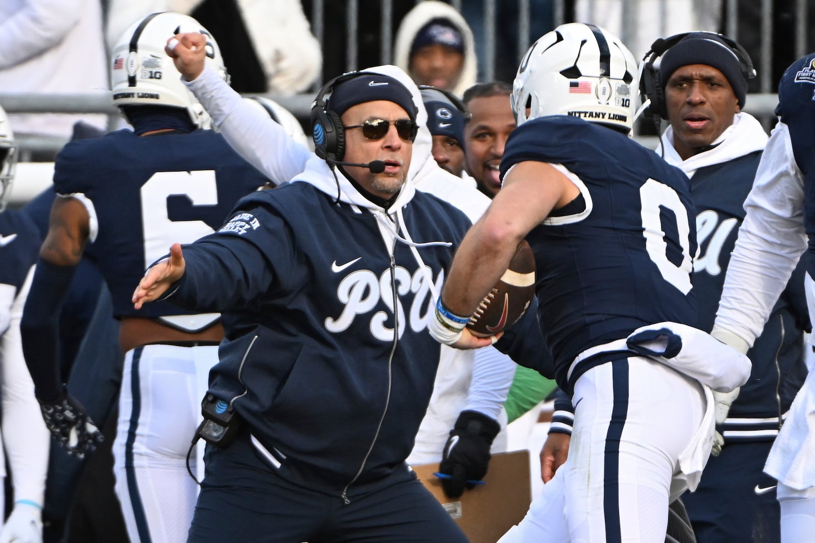 Penn State linebacker Dominic DeLuca celebrates an interception for a touchdown with head coach James Franklin against SMU during the first half in the first round of the NCAA College Football Playoff, Saturday, Dec. 21, 2024, in State College, Pa. (AP Photo/Barry Reeger)