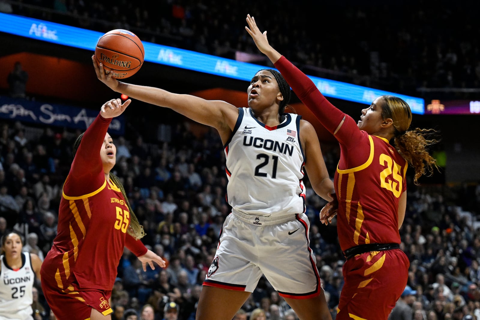 UConn forward Sarah Strong (21) shoots between Iowa State center Audi Crooks (55) and Iowa State guard Sydney Harris (25) in the first half of an NCAA college basketball game, Tuesday, Dec. 17, 2024, in Uncasville, Conn. (AP Photo/Jessica Hill)