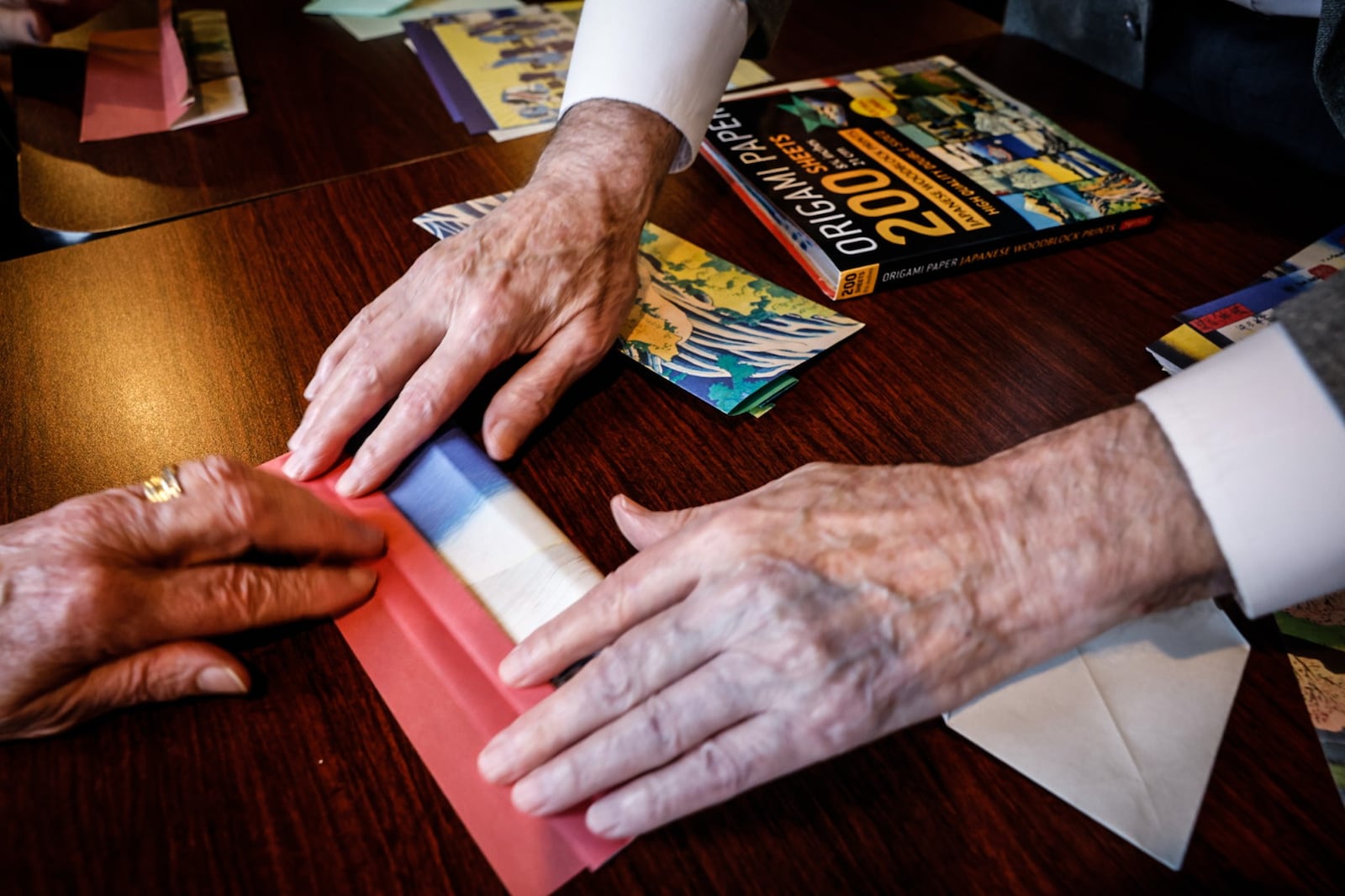 Origami practitioner Joe Scullon teaches origami to a small group at Chiapas Restaurant. JIM NOELKER/STAFF