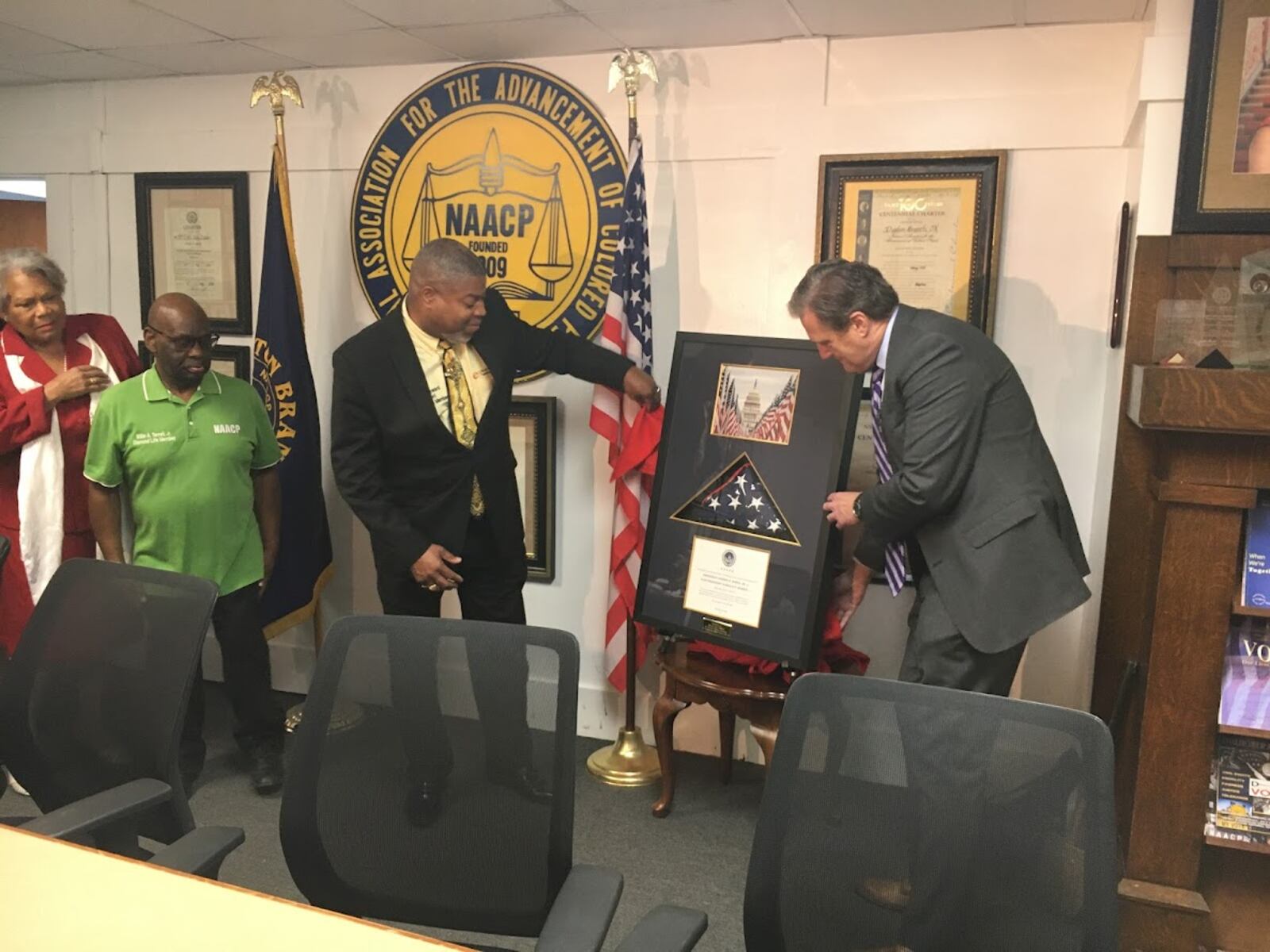 Dr. Derrick Foward (left), president of the Dayton chapter of the NAACP, with U.S. Rep. Mike Turner, R-Dayton, receiving his inaugural flag Friday Nov. 12. THOMAS GNAU/STAFF