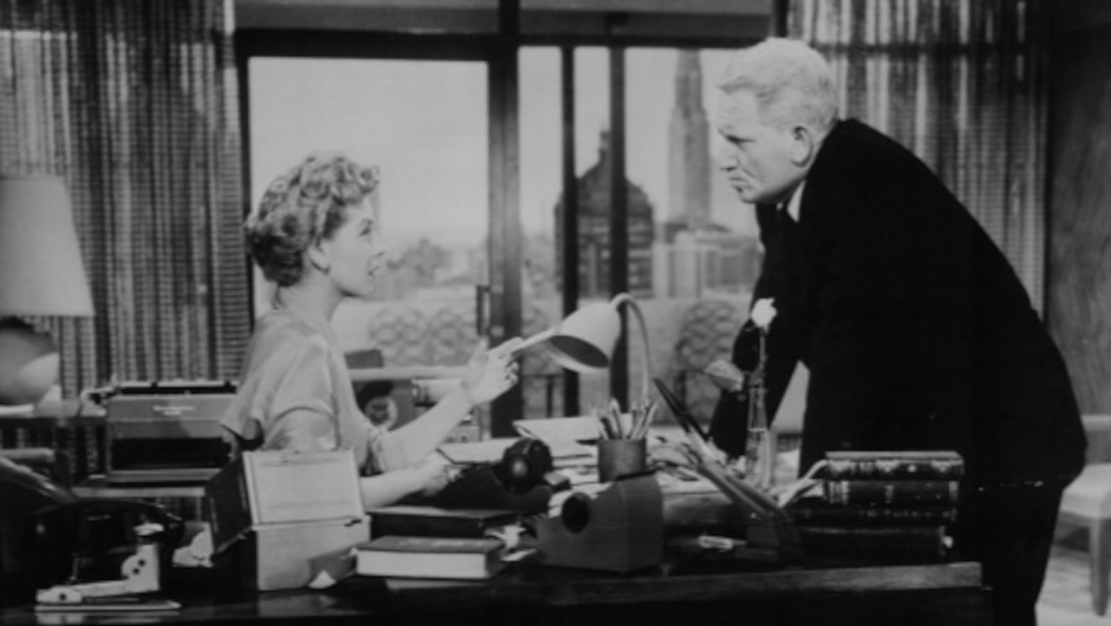 Dina Merrill looking up at a disappointed Spencer Tracy in a scene from the film 'Desk Set', 1957. (Photo by 20th Century-Fox/Getty Images)