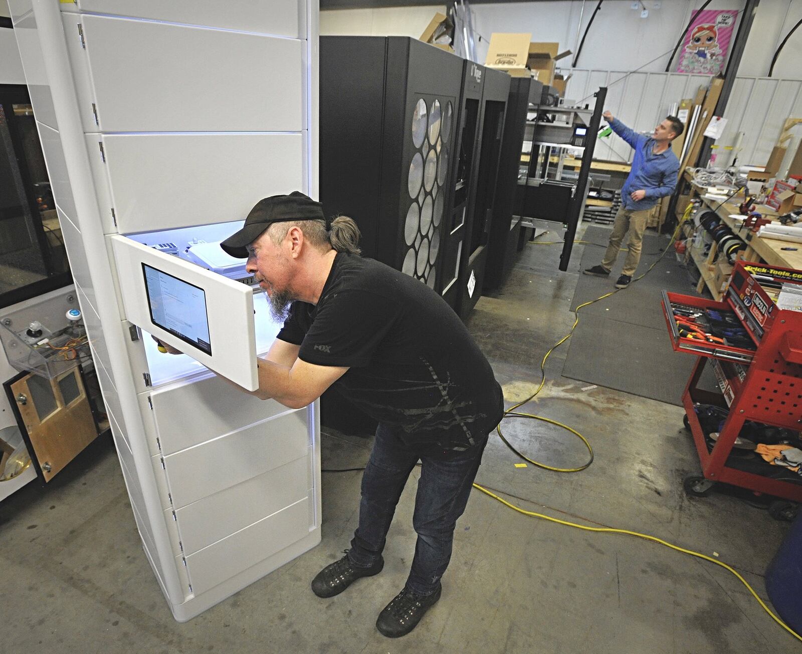 Innovative Vending Solutions, technician Michael McDonald works one of the companies newest vending machines. Staff Photo Marshall Gorby