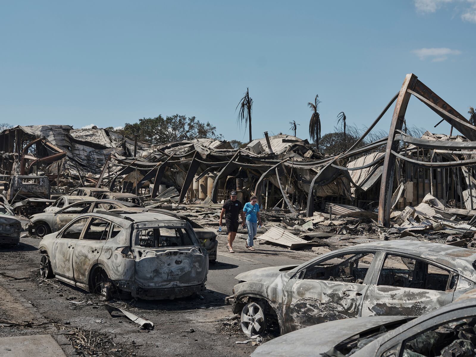 
                        People survey the ruins of Lahaina, Hawaii, two days after the historic town on Maui was devastated by wildfire, Aug. 11, 2023. Climate change, inflation and global instability have thrust companies that sell insurance to insurers into the spotlight. (Philip Cheung/The New York Times)
                      