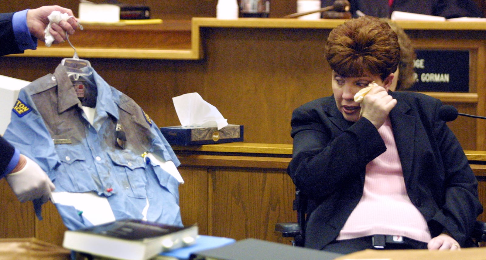 Dayton Police Officer Mary Beall wipes away tears Tuesday, February 13, 2001, in Montgomery County Common Pleas Court as she identifies the uniform she was wearing last May, the day she was shot by Raham Twitty.