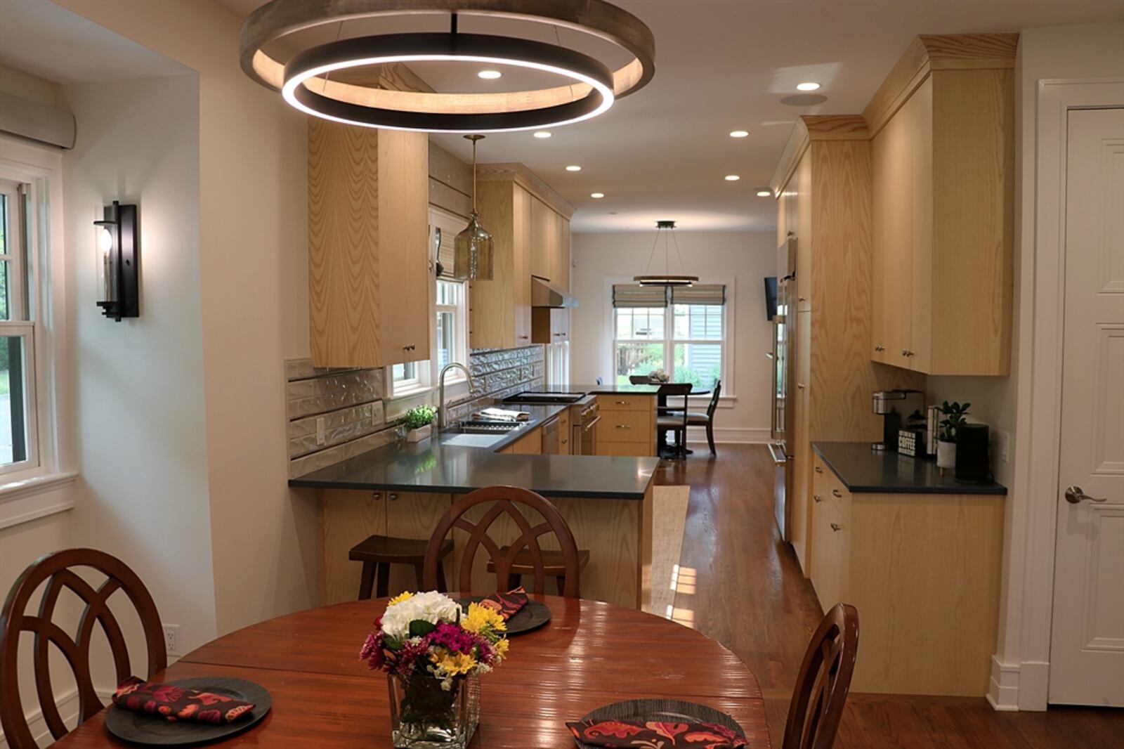 The open space flows from the dining area into the redesigned kitchen into the breakfast room.