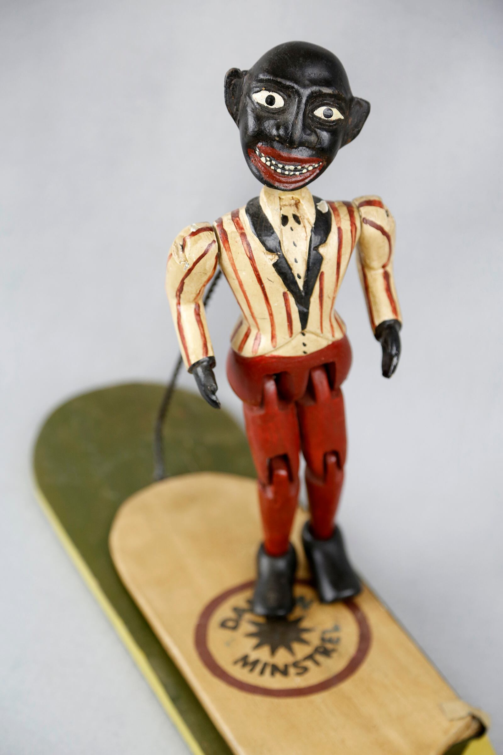 A "Jig Doll" is part of the National Afro-American Museum & Cultural Center in Wilberforce. The toy was mass produced in the mid-twentieth century with a body made of painted wood. A spring attached the puppet makes him "dance" when the paddle is tapped. LISA POWELL / STAFF