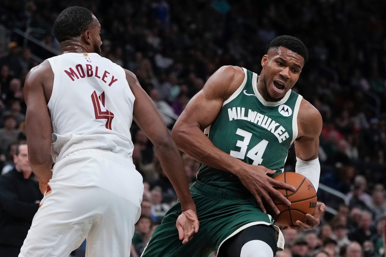 Milwaukee Bucks' Giannis Antetokounmpo is fouled by Cleveland Cavaliers' Evan Mobley during the first half of an NBA basketball game Saturday, Nov. 2, 2024, in Milwaukee. (AP Photo/Morry Gash)