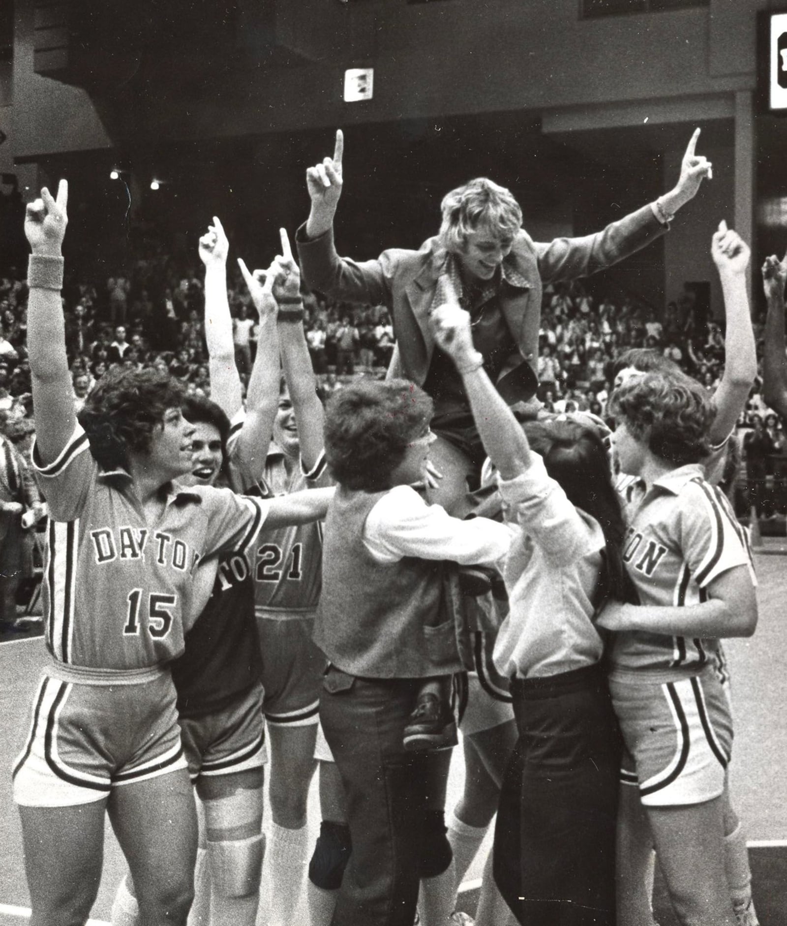 The University of Dayton Flyer women lift Coach Maryalyce Jeremiah onto their shoulders while celebrating their 1980 national championship. DAYTON DAILY NEWS ARCHIVE