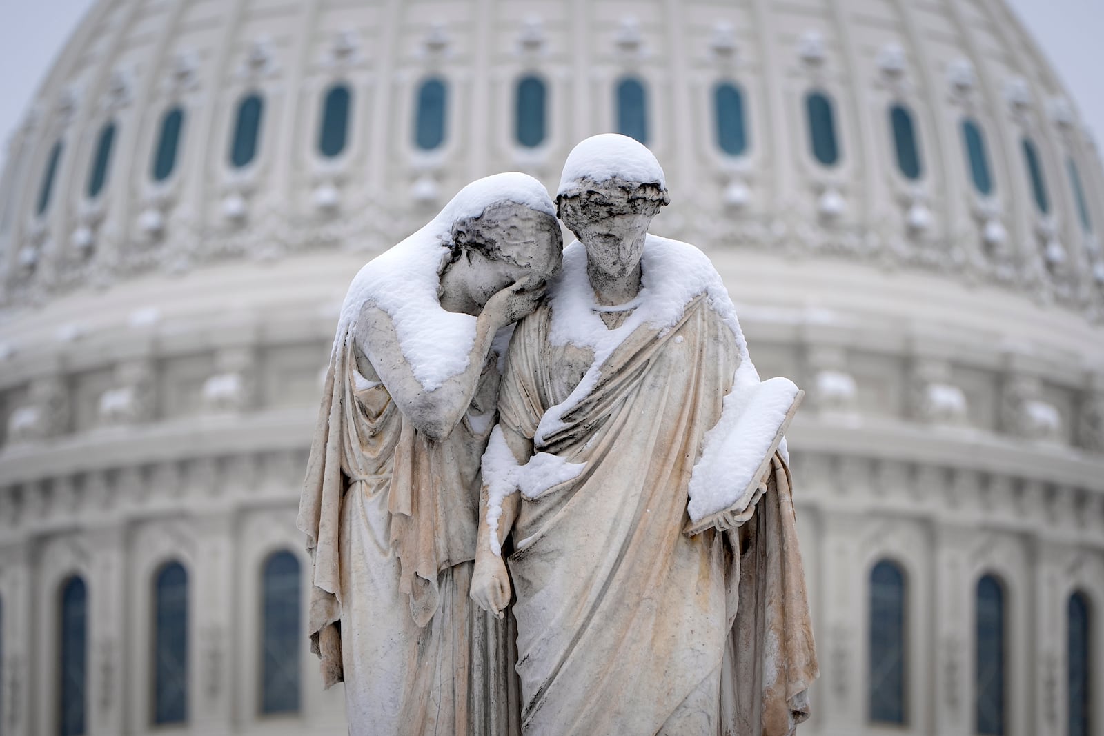 The Peace Monument, also known as the Naval Monument or Civil War Sailors Monument, is covered by snow outside the Capitol, Wednesday, Feb. 12, 2025, after a snowstorm in Washington. (AP Photo/Jacquelyn Martin)