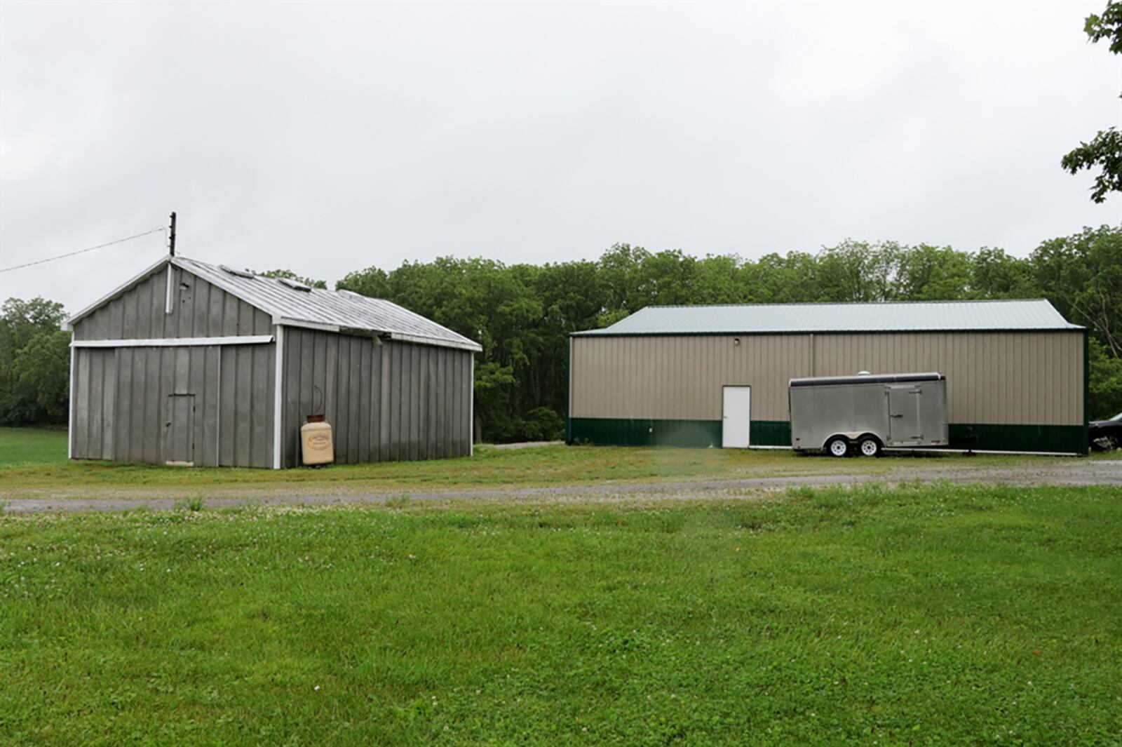 A pole barn near the main house has an oversized overhead door, concrete floor, electric and door opener for a multi-vehicle garage and workshop. Near the pole barn is a heated workshop with tin roof. CONTRIBUTED PHOTO BY KATHY TYLER