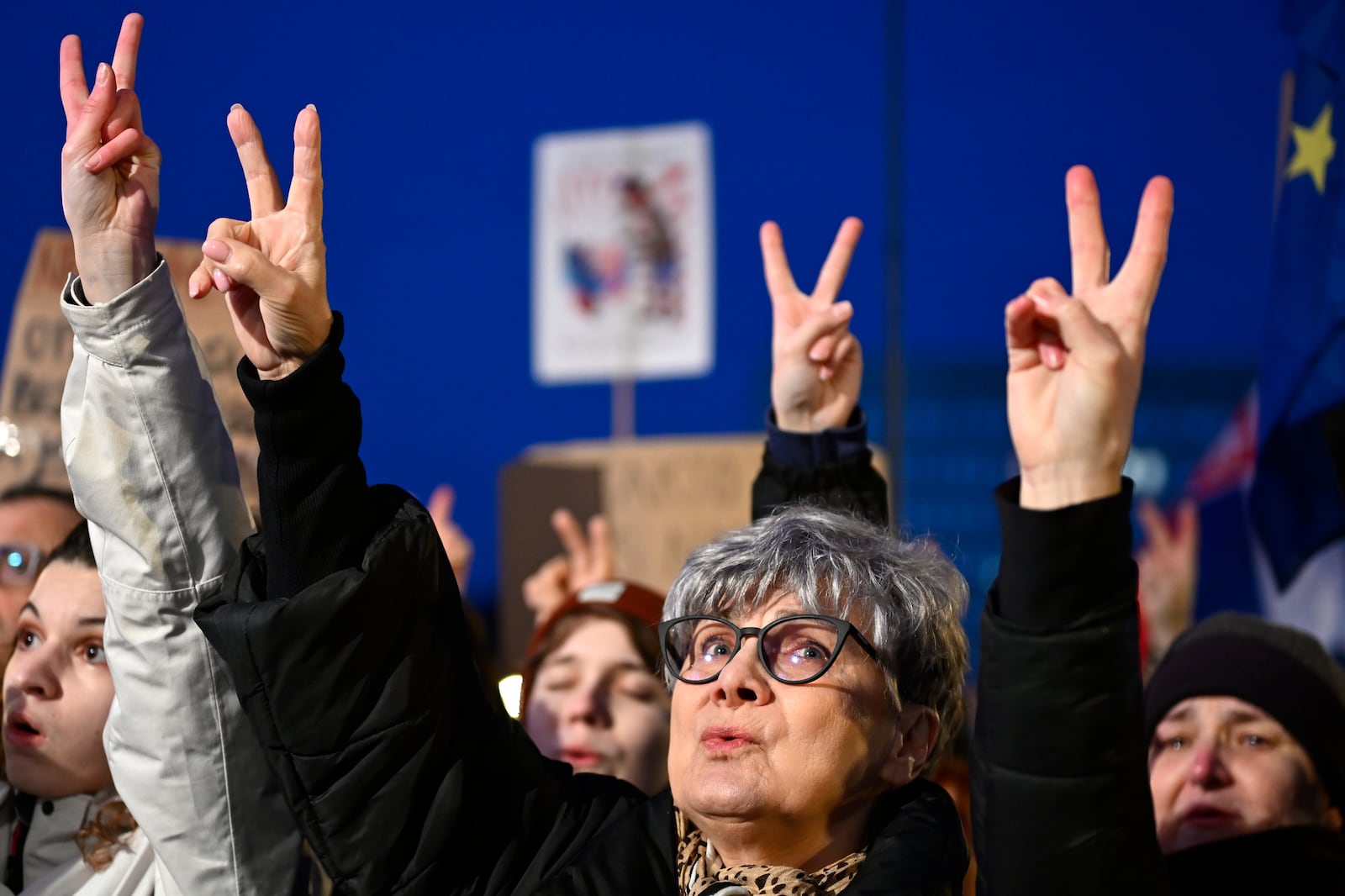 Protesters strike the v sign as thousands gather to oppose the policies of Slovakia's Prime Minister Robert Fico in Bratislava, Slovakia, Friday, Jan. 24, 2025. (AP Photo/Denes Erdos)