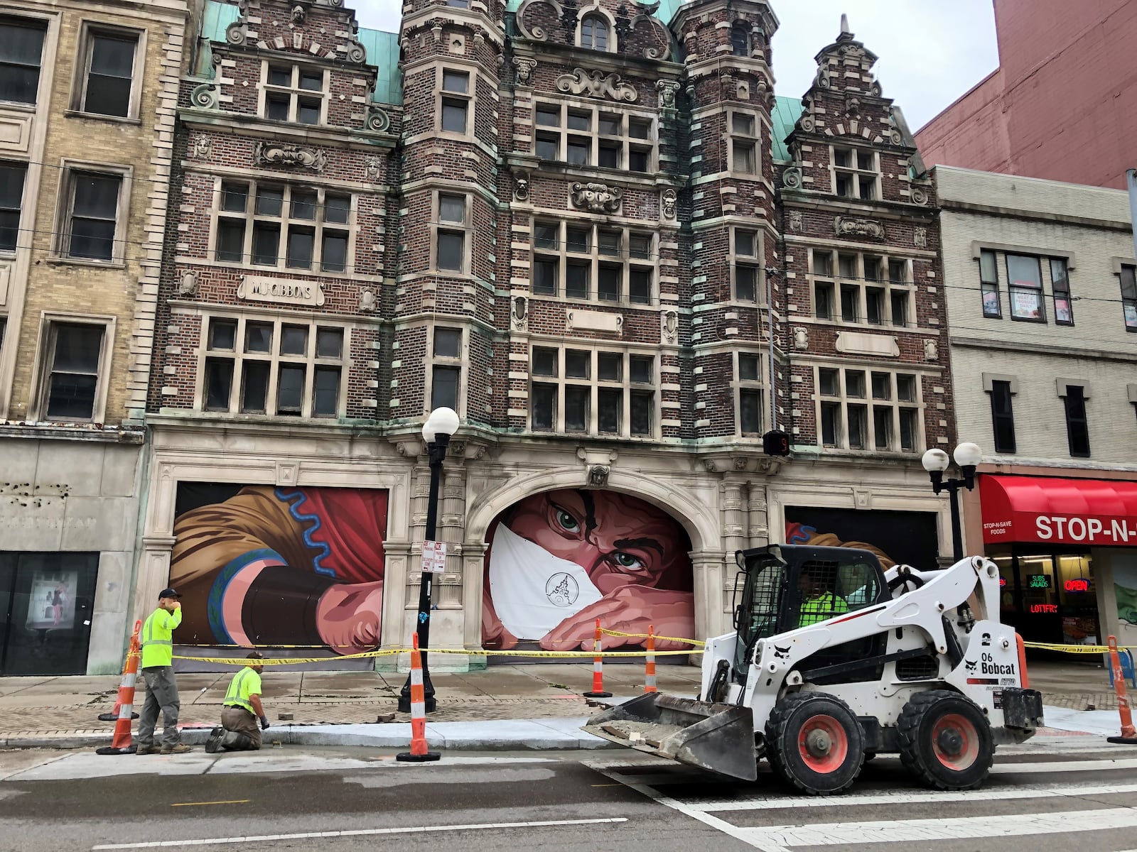 Crews work along East Third Street in front of the Third Street entrance to the Dayton Arcade. CORNELIUS FROLIK / STAFF