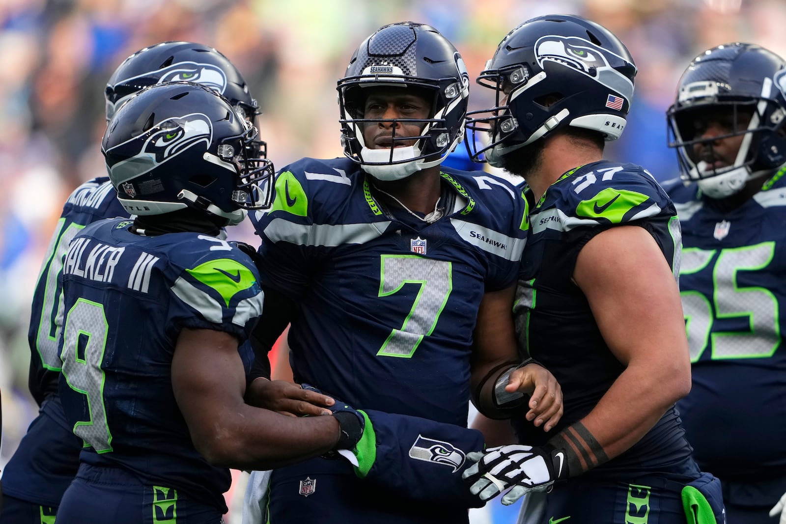 Seattle Seahawks running back Kenneth Walker III (9) celebrates quarterback Geno Smith (7) and teammates during the first half of an NFL football game against the Los Angeles Rams in Seattle, Sunday, Nov. 3, 2024. (AP Photo/Lindsey Wasson)