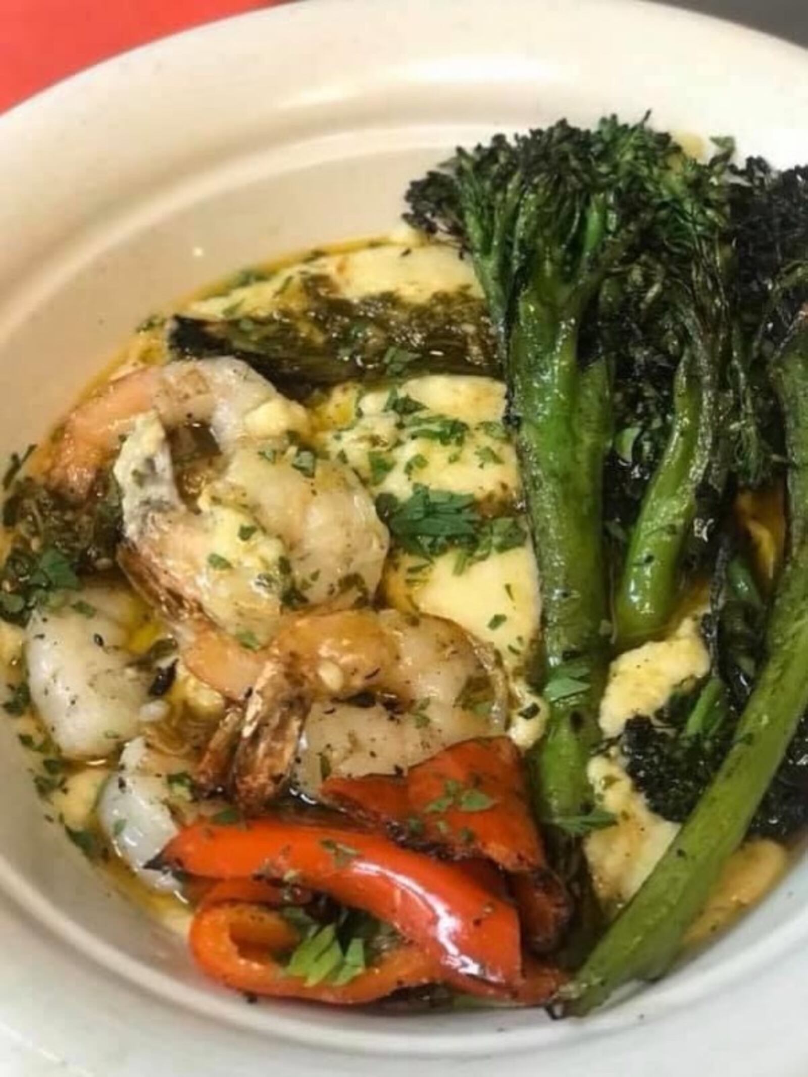 Wheat Penny's grilled shrimp, broccolini and peppers with polenta. Grilled with the vegetables, tumbled over polenta parmigiana and garnished with lemon oil and a drizzle of salsa verde. CONTRIBUTED