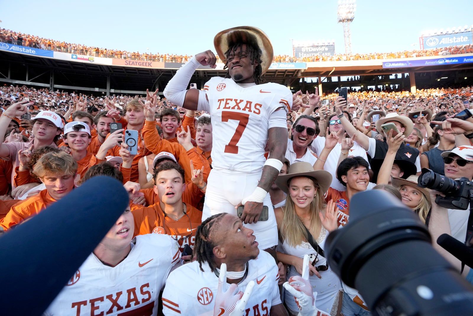 Texas defensive back Jahdae Barron (7) wears the Golden Hat Trophy as he celebrates the team's win against Oklahoma with fans after an NCAA college football game in Dallas, Saturday, Oct. 12, 2024. (AP Photo/Jeffrey McWhorter)