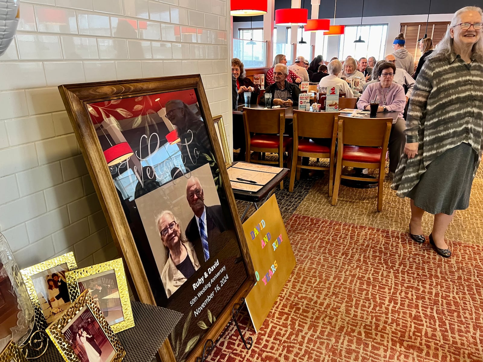 Ruby Crews, right, stands in front of a crowd of her closest friends and family, all of whom gathered at the Frisch's in Kettering to celebrate her marriage of 50 years to husband, David. AIMEE HANCOCK/STAFF