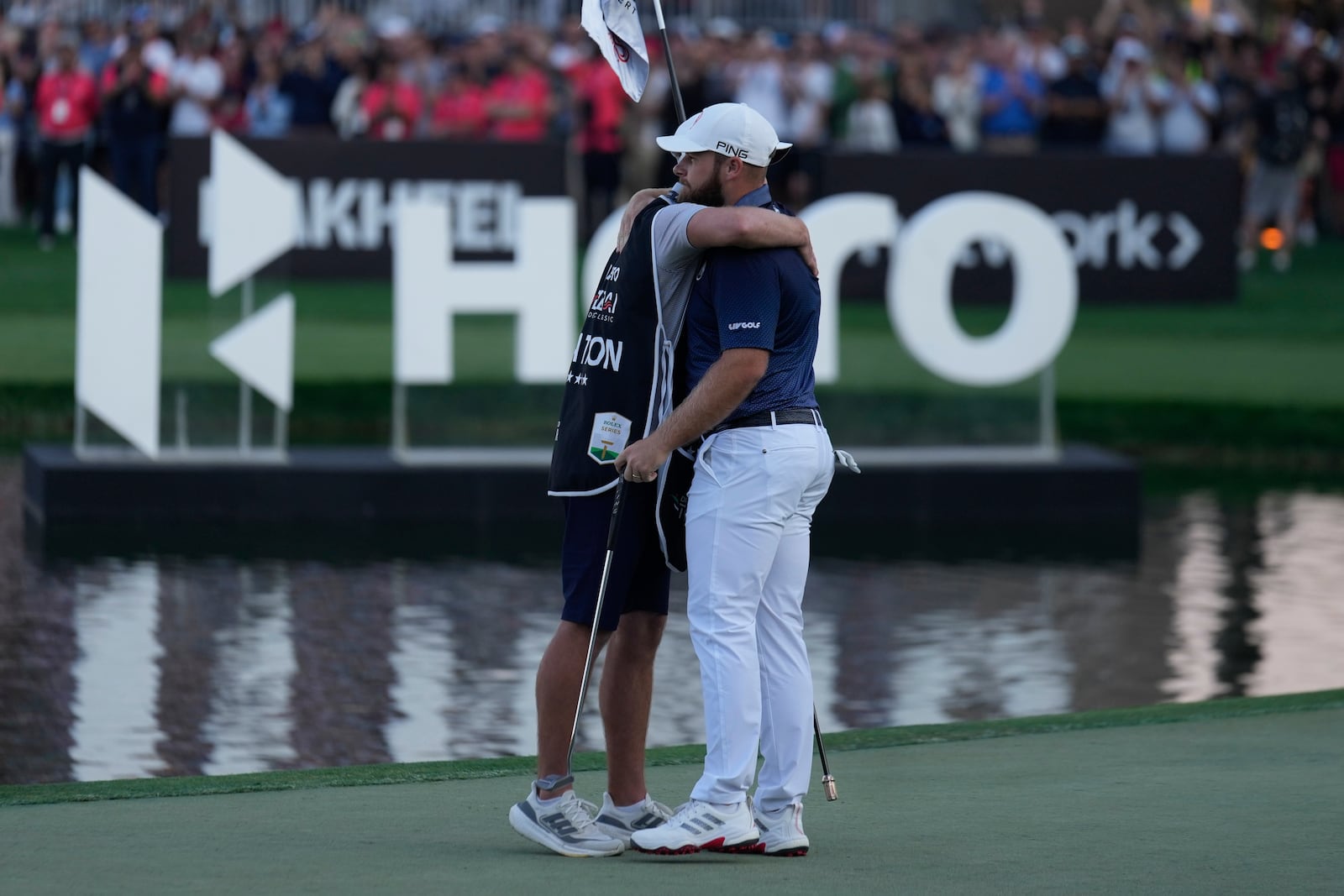 Tyrell Hatton of England and his caddie celebrate after winning the Dubai Desert Classic golf tournament, in Dubai, United Arab Emirates, Sunday, Jan. 19, 2025. (AP Photo/Altaf Qadri)