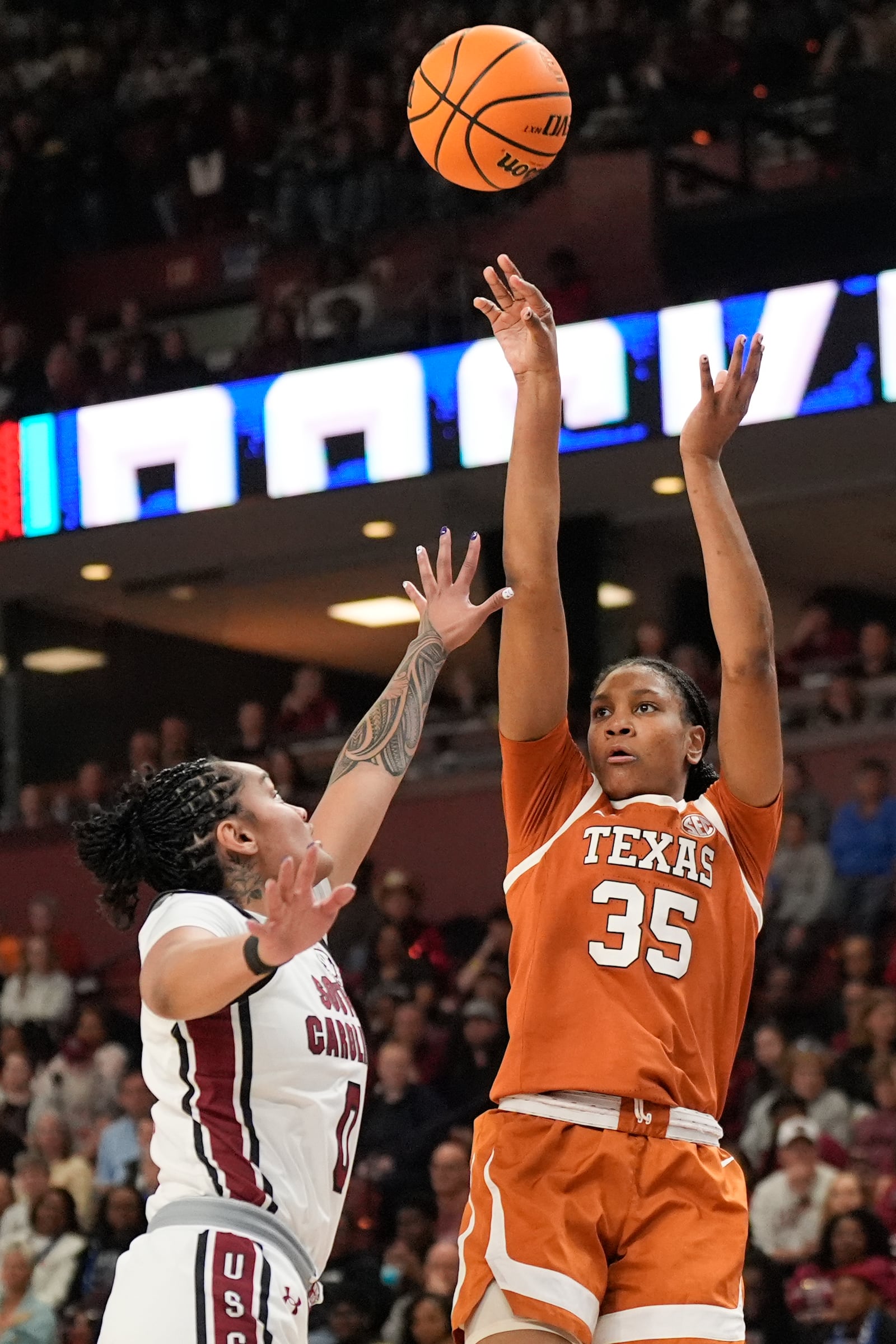 Texas forward Madison Booker shoots over South Carolina guard Te-Hina Paopao during the first half during of an NCAA college basketball game in the final of the Southeastern Conference tournament, Sunday, March 9, 2025, in Greenville, S.C. (AP Photo/Chris Carlson)