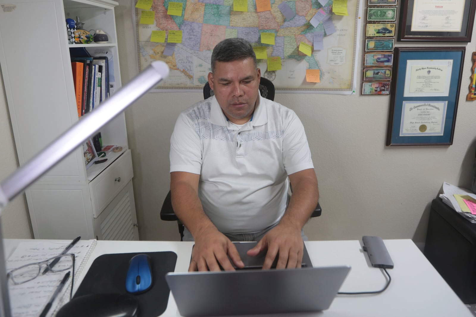 José Palma, a 48 year-old Salvadoran who has lived in the U.S. since 1998, works in home in Texas on Wednesday, Jan. 8, 2025. (AP Photo/Lekan Oyekanmi)