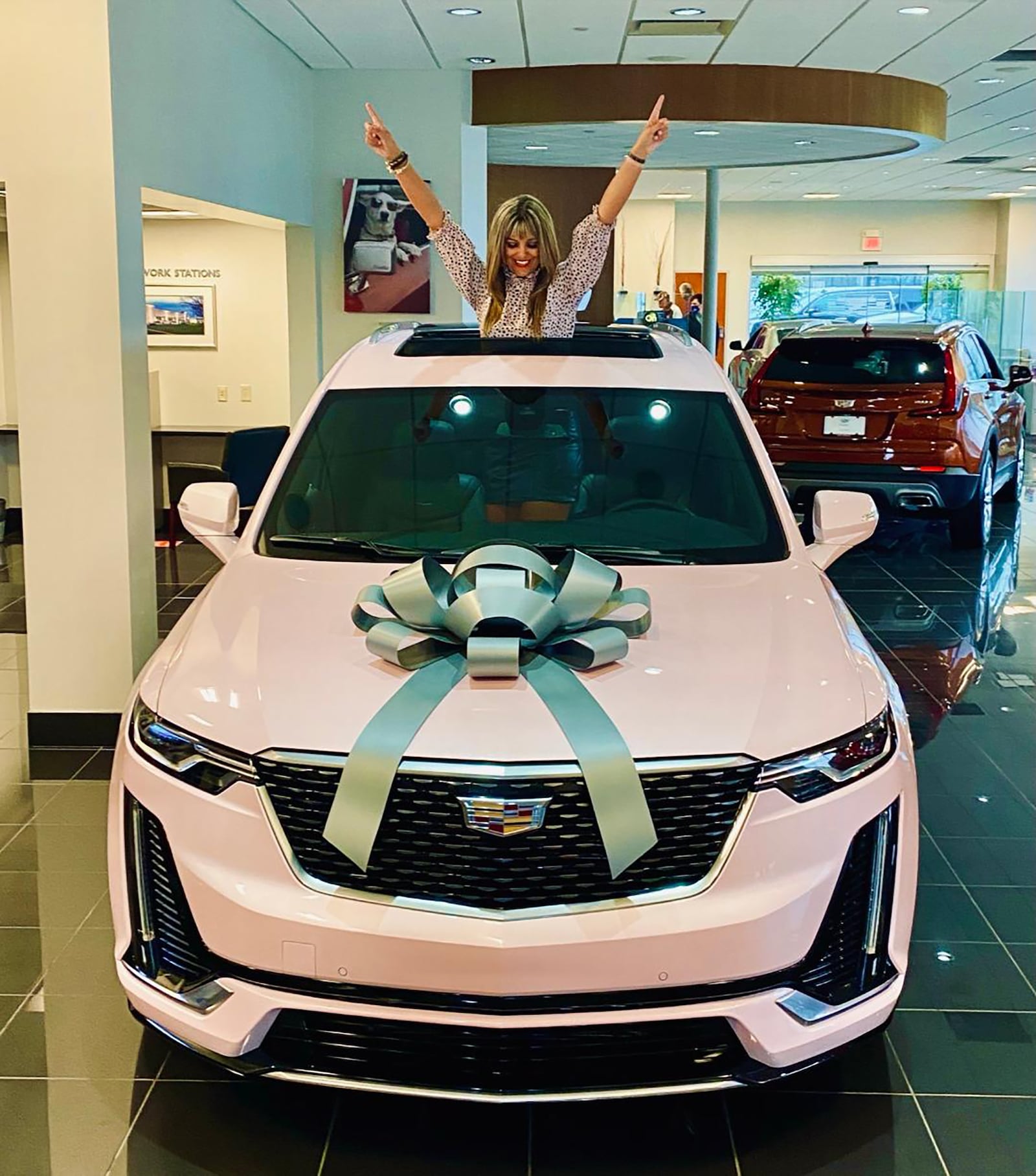 In 2010, Frantz earned her first Mary Kay pink Cadillac. Here she celebrates at Voss Village Cadillac where she picked up her car.