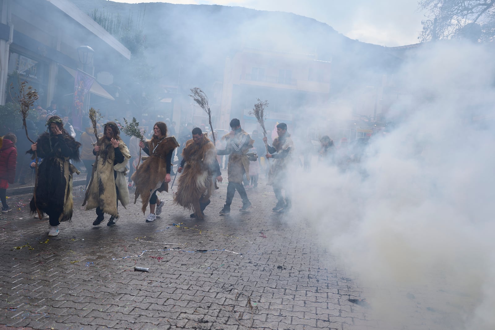 Revellers dressed in animal skins and heavy bronze bells, dance during carnival celebrations in Distomo, a village in central Greece, on Monday, March 3, 2025. (AP Photo/Petros Giannakouris)