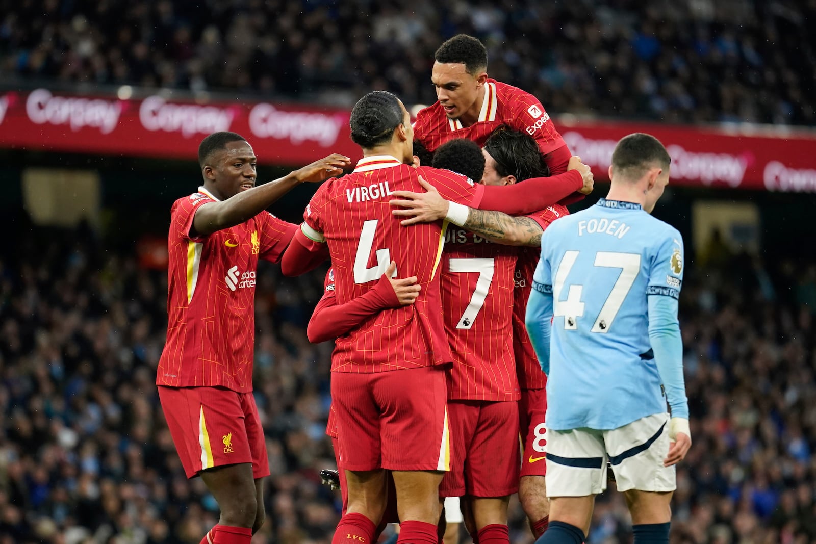 Liverpool's Mohamed Salah is congratulated after scoring his side's opening goal during the English Premier League soccer match between Manchester City and Liverpool at Etihad stadium in Manchester, England, Sunday, Feb. 23, 2025. (AP Photo/Dave Thompson)