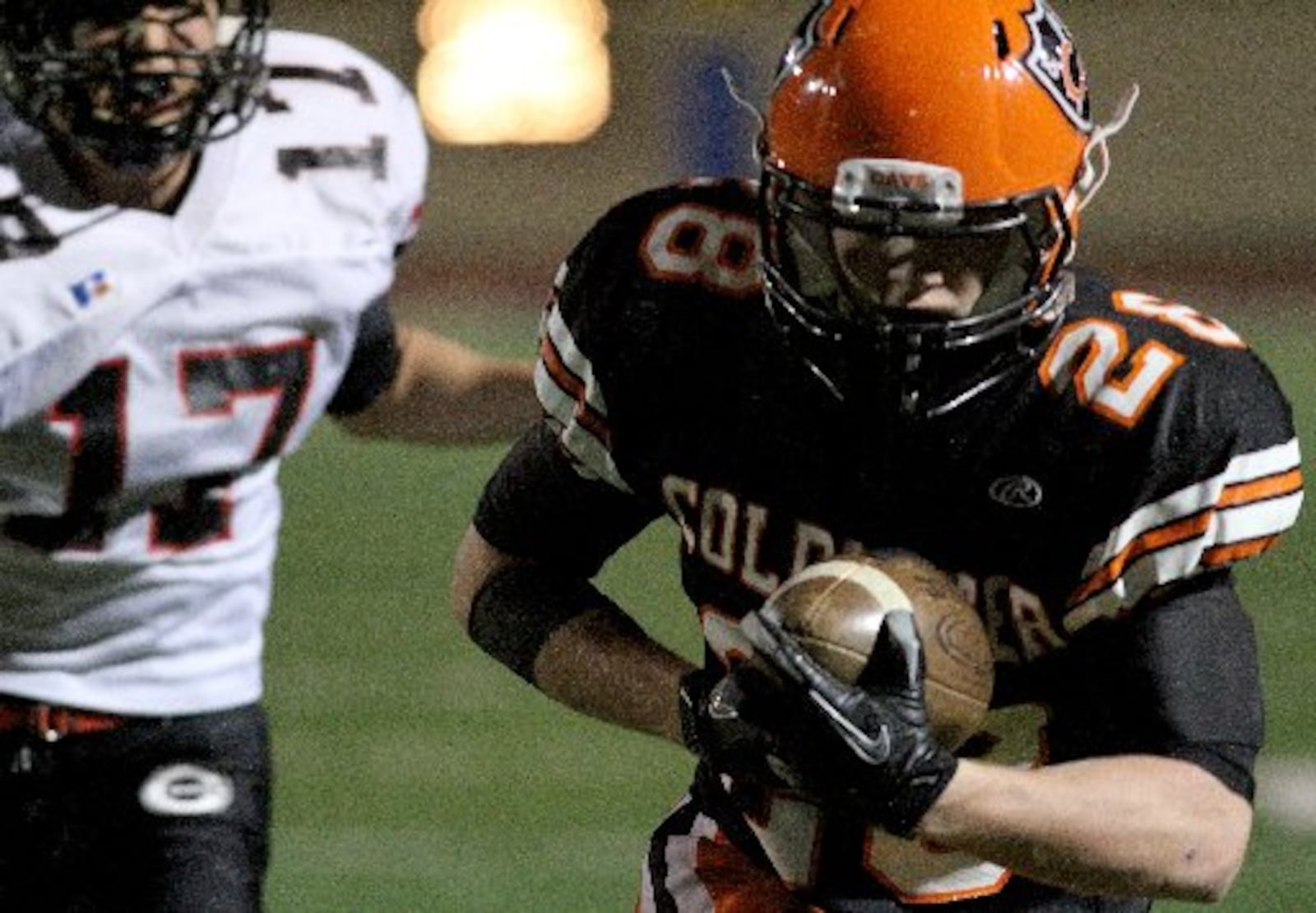 Coldwater wide receiver Caleb Siefring carries a reception in for a touchdown as Covington defensive back Kyler Deeter pursues during their playoff game at Welcome Stadium in Dayton Saturday, Nov. 17, 2012. E.L. Hubbard photography.