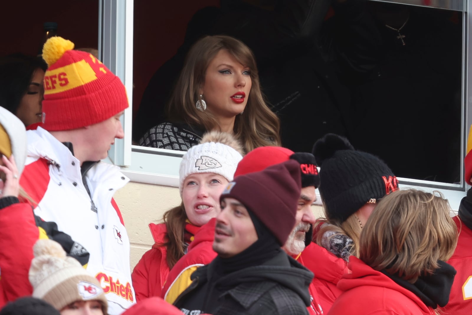 Taylor Swift watches from a suite during the first half of an NFL football AFC divisional playoff game between the Kansas City Chiefs and the Houston Texans Saturday, Jan. 18, 2025, in Kansas City, Mo. (AP Photo/Travis Heying)