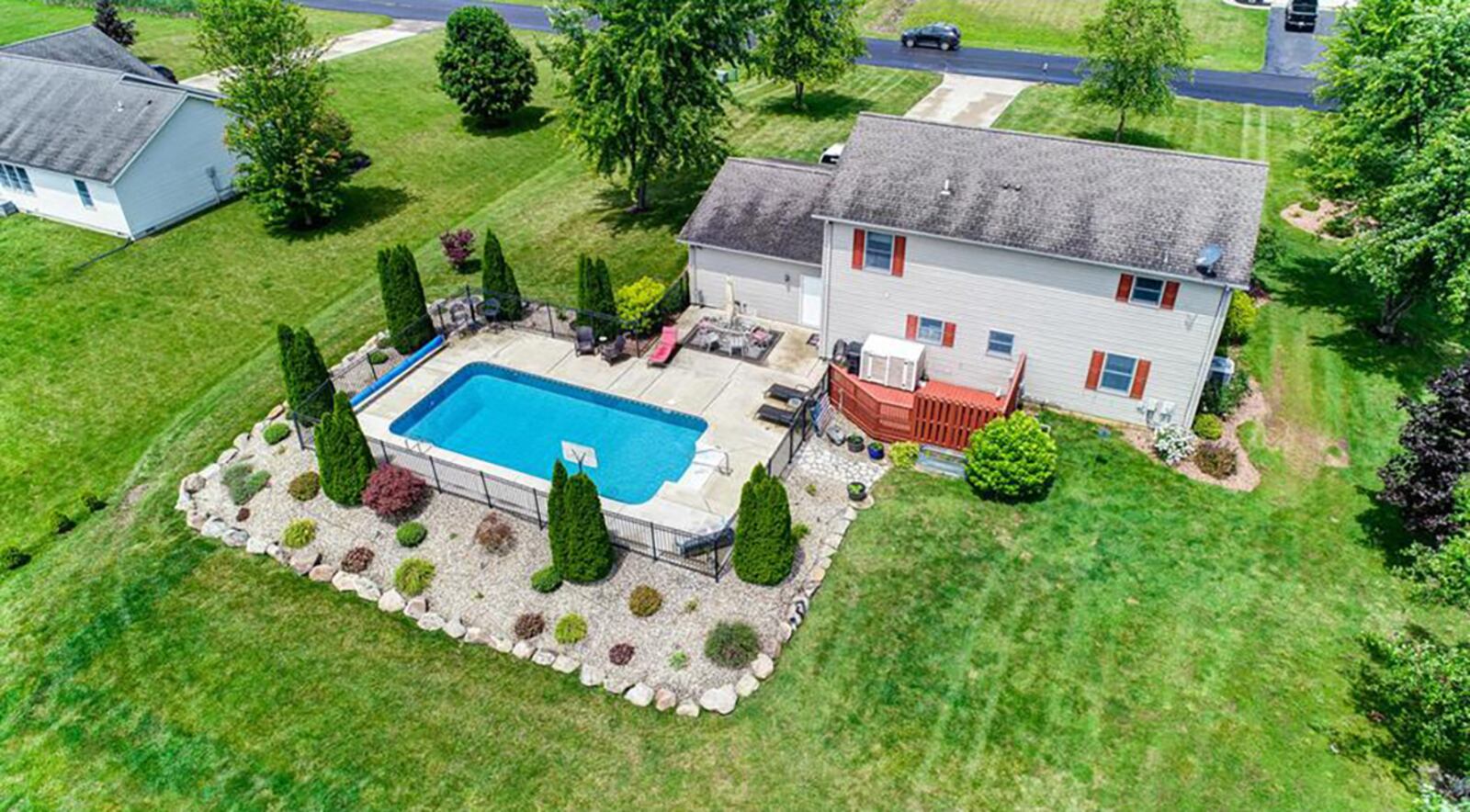 The lot is 1 acre and features a fully fenced in-ground pool with large concrete patio. There is also a large yard barn in the back.