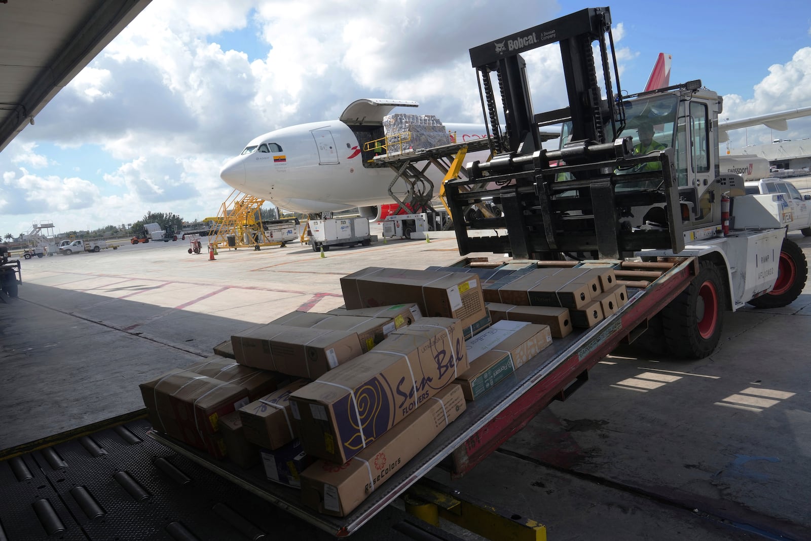 Boxes of flowers arrive from Colombia Friday, Feb. 7, 2025, at Miami International Airport, in Miami. (AP Photo/Marta Lavandier)