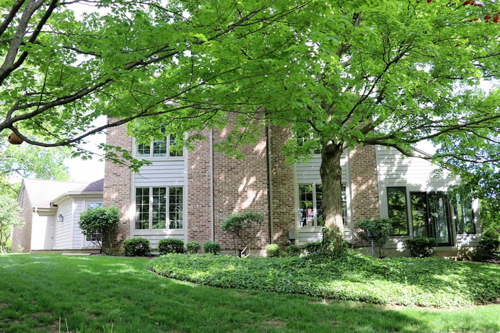 Straight off the foyer is the combined living and dining room. A brick fireplace is flanked by picture windows that were updated in 2018. The windows provide views of the open green space with rolling hills and footbridge. CONTRIBUTED PHOTO BY KATHY TYLER