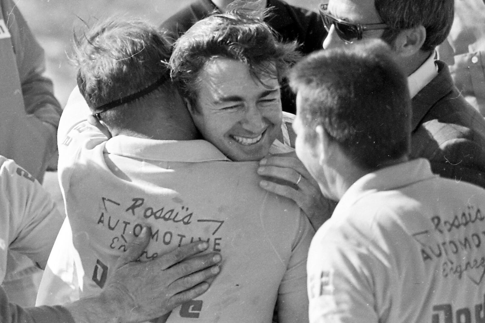 FILE - Bobby Allison, facing camera, is hugged by his pit crew after winning the Atlanta 500 stock car race, March 29, 1970 at the Atlanta International Raceway in Hampton, Ga. (AP Photo/File)