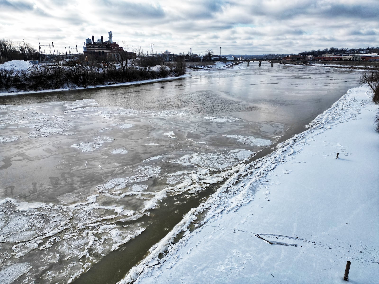 Ice forms on the surface of the Great Miami River at Combs Park in Hamilton Tuesday, Jan. 16, 2023 after several days of below freezing temperatures in the area. NICK GRAHAM/STAFF