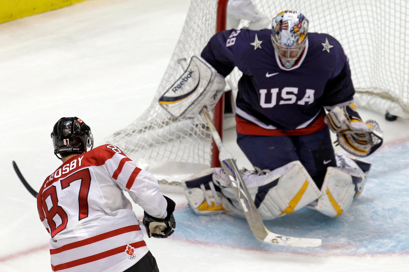 FILE - Canada's Sidney Crosby (87) shoots past USA goalie Ryan Miller (39) for the game-winning goal in the overtime period of a men's gold medal ice hockey game at the Vancouver 2010 Olympics in Vancouver, British Columbia, Sunday, Feb. 28, 2010. (AP Photo/Chris O'Meara)