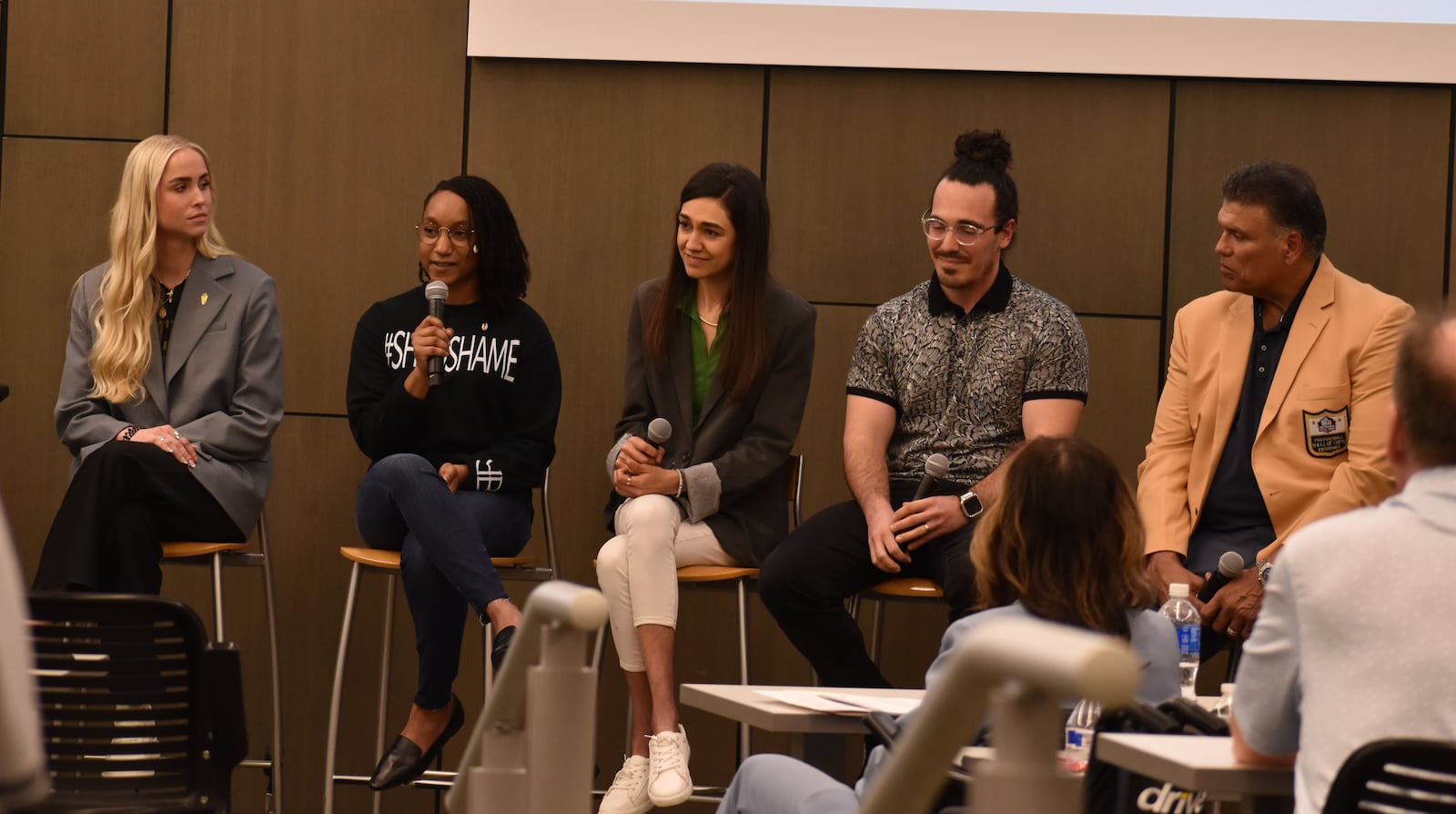 From left to right, Alicia Donley, a former college athlete; Kendra Williams, a mental health advocate; Alexandra Miles, founder and CEO of Project Blackbird; Dr. Troy Baker, a clinical psychologist; and Anthony Muñoz, former offensive tackle for the Cincinnati Bengals who was also inducted into the Pro Football Hall of Fame in 1998, speaking during a recent Project Blackbird event at Wright State University on March 19, 2025. Panelists shared their challenges with mental health, along with messages of hope. SAM WILDOW/STAFF